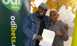 File Image of Kaveve Kazoze Hitmaker ‘Ngesh’ with Odibets General Manager Dedan Mungai.